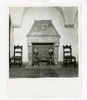 Generated thumbnail: Ornate fireplace with decorative andirons and chairs in Graylyn manor reception hall