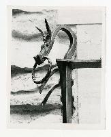 Generated thumbnail: Close-up of dragon ironwork detail from exterior balcony