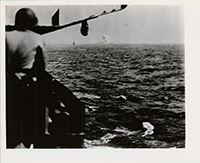 Generated thumbnail: View of 4th USS Princeton (CLV23) on fire east of Luzon October 24, 1944. Airplane and crewman in foreground.