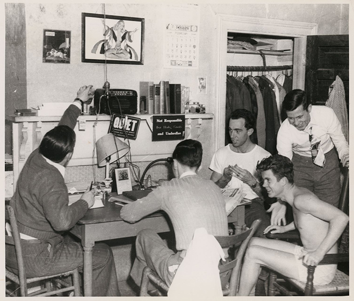 Five young men relax in a student bedroom at the "Crudup mansion"