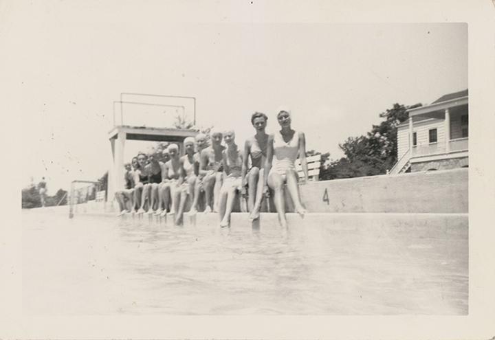 Twelve women sit on the edge of the Wake Forest Community Center pool
