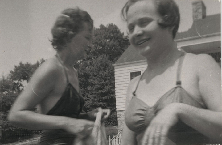 Two women in bathing suits at a swim event for the Women's Health Club