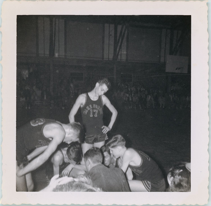 Harvey Holding standing at the center of the Wake Forest High School basketball team