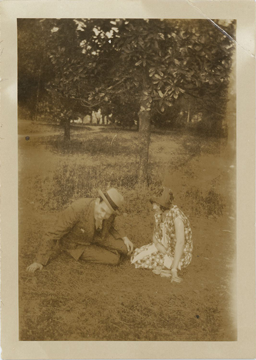 Man and woman sitting in front of magnolia trees
