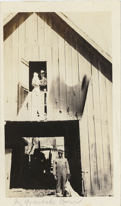 Thomas Arrington II and III in barn loft with unidentified farm worker below